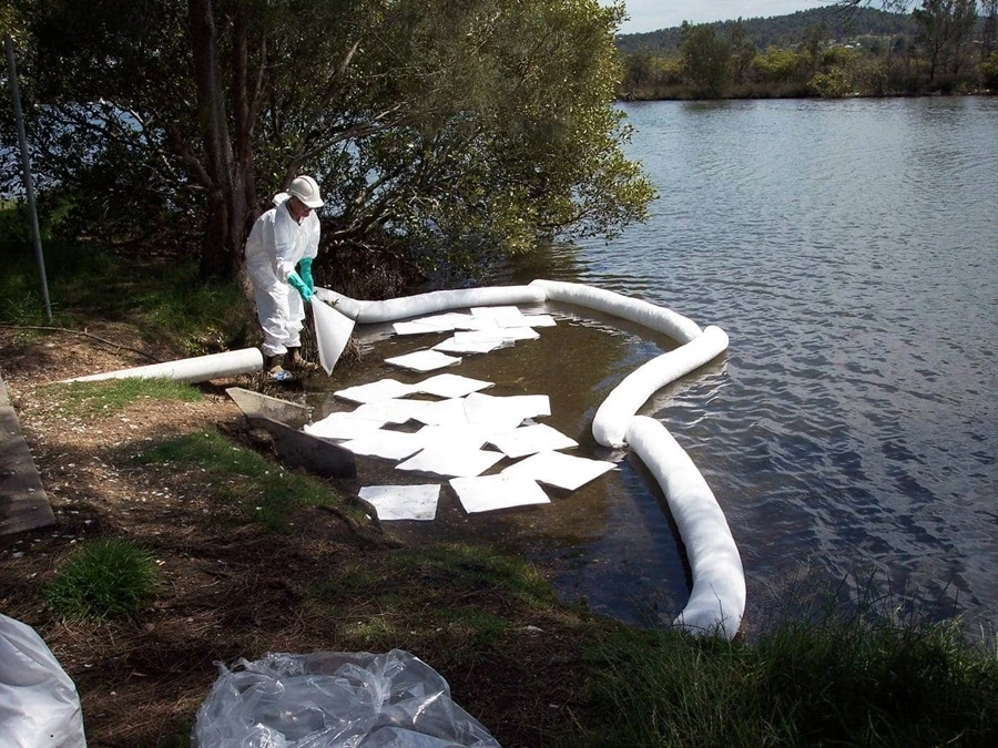 Floating boom deployed on water to contain an oil spill